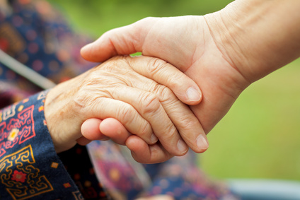 Older patient holding a doctor's hand in Dallas, TX