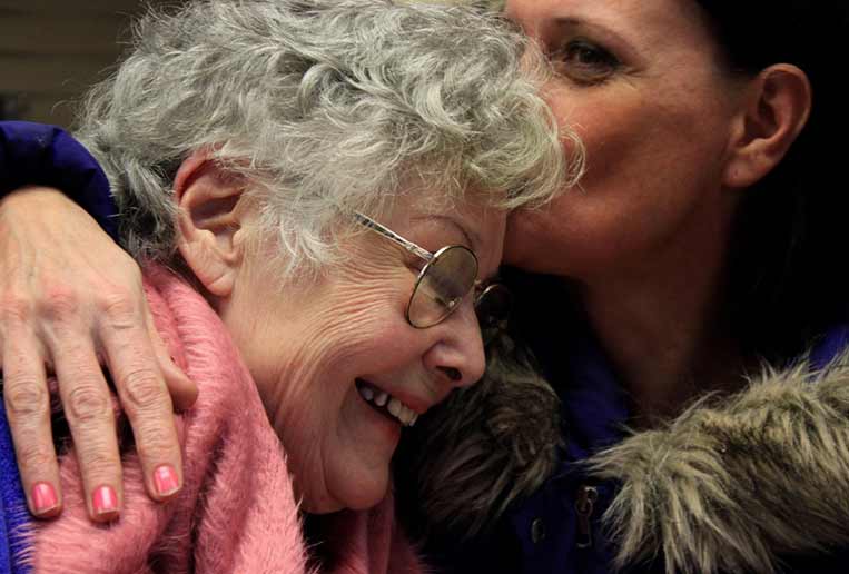 Senior mother smiling with her daughter in Dallas, TX