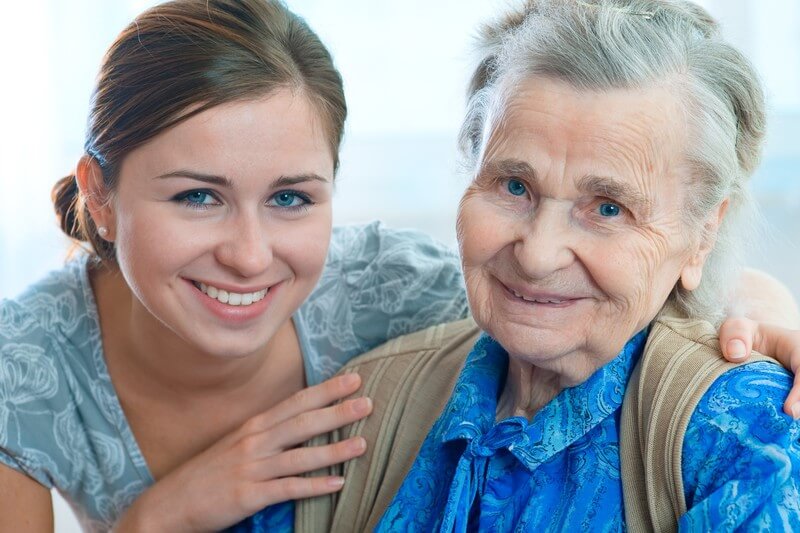 Older woman wearing blue with her daughter in Dallas, TX